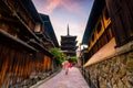 Japanese girl in Yukata with red umbrella in old town Kyoto