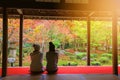 Japanese girls in Enkoji temple enjoy Autumn colorful garden