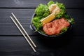 Japanese or asian cuisine. Salad with fresh or raw red fish with lettuche, lemon and ginger Royalty Free Stock Photo