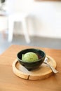 Japanese green tea ice cream with red bean topping on wooden table in coffee shop Royalty Free Stock Photo