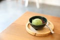 Japanese green tea ice cream with red bean topping on wooden table in coffee shop Royalty Free Stock Photo