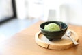 Japanese green tea ice cream with red bean topping on wooden table in coffee shop Royalty Free Stock Photo