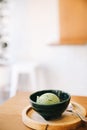 Japanese green tea ice cream with red bean topping on wooden table in coffee shop Royalty Free Stock Photo