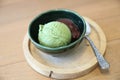 Japanese green tea ice cream with red bean topping on wooden table in coffee shop Royalty Free Stock Photo