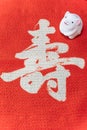 A Japanese greeting card with a cute rat figurine for the 2020 year of the mouse on a red cloth