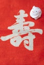 A Japanese greeting card with a cute rat figurine for the 2020 year of the mouse on a red cloth