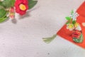 A Japanese greeting card with a Tsubaki flower also called the winter rose and a folklore animal figurine depicting Shishimai lion