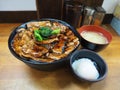 Japanese grilled barbecue pork top on rice in a bowl serve with soft-boiled eggs and soup Royalty Free Stock Photo