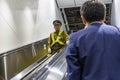 The Japanese Guard Is Going Down On The Escalator Royalty Free Stock Photo