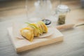 Japanese guiozas with soya sauce on wooden chopping table