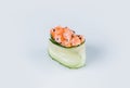 Japanese Gunkan Green Kappa Sushi with salmon and flying fish roe wrapped in cucumber.