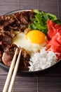Japanese gyudon beef with rice, ginger and onions closeup. vertical