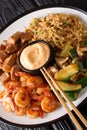 Japanese hibachi lunch made of fried rice, shrimp, steak and vegetables close-up on the table. vertical Royalty Free Stock Photo