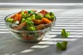 Japanese hot appetizers with peas and wasabi lie in a glass bowl on a white background, consecrated by the sun`s rays passing