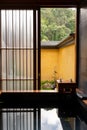 Japanese hot spring bathroom with boiling water for rest and relax when open wooden window for get some fresh air and garden view Royalty Free Stock Photo
