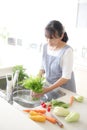 Japanese housewife washing vegetables Royalty Free Stock Photo