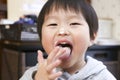 Japanese infant eating a pinch Royalty Free Stock Photo