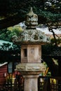 Japanese Ishi-doro stone lantern in Japan and trees in the background