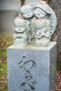 Japanese Jizo Stone statue with maple leaf at Autumn in Eikando Temple. maple momiji season image.