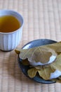 Japanese Kashiwa mochi and green tea on tatami. Royalty Free Stock Photo