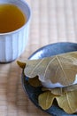 Japanese Kashiwa mochi and green tea on tatami. Royalty Free Stock Photo