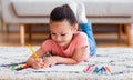 Japanese Kid Girl Drawing Using Pencils Lying On Floor Indoor