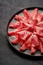 Japanese kobe beef sliced on ceramic plate on black background