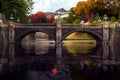 Japanese lady in Kimono dress stand on stone bridge in Imperial place