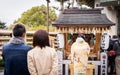 Japanese lady is praying in a shrine.