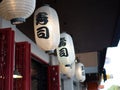 Japanese lantern hung in front of Japanese Restaurant, Japanese text on lantern is \
