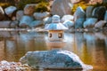 Japanese lantern statue stands alone on a peninsula in the japanese gardens