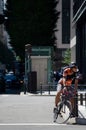 Japanese man on bicycle waiting for the signal change is taken in Marunouchi, Japan. Marunouchi is the business district in Tokyo.