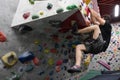 A Japanese man climbing a rock wall indoor. Royalty Free Stock Photo