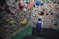 A Japanese man climbing a rock wall indoor. Royalty Free Stock Photo