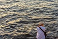 Japanese man with a fishing rod fishing at seashore in Osaka Bay, Japan