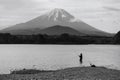 Japanese man fishing on Shoji lake with mount Fuji, Yamanashi, Japan Royalty Free Stock Photo