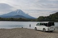 Japanese man fishing on Shoji lake by van car with mount Fuji view Royalty Free Stock Photo