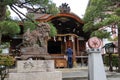 Japanese man praying at Daishogun Hachi-jinja Shrine in Kyoto, Japan.