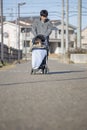 Japanese man pushing a stroller Royalty Free Stock Photo