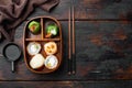 Japanese Meal in a Box Bento with sushi roll eice avocado salmon fish, on old dark  wooden table background, top view flat lay , Royalty Free Stock Photo