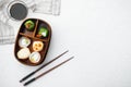 Japanese Meal in a Box Bento with sushi roll eice avocado salmon fish, on white stone  background, top view flat lay , with Royalty Free Stock Photo