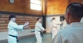 Japanese men, aikido class and instructor for fighting, modern martial arts and learning self defence. Teacher, students Royalty Free Stock Photo