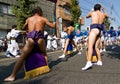 Japanese men in sumo belts dance in a parade Royalty Free Stock Photo