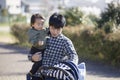 Japanese man taking care of baby in stroller Royalty Free Stock Photo