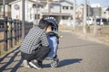 Japanese man taking care of baby in stroller Royalty Free Stock Photo