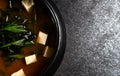 Japanese miso soup in a black bowl on rustic stone Royalty Free Stock Photo