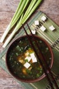 Japanese miso soup in a brown bowl vertical top view