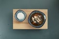 Japanese miso soup and rice on a red bowl and spoon on the table.