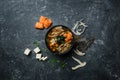 Japanese miso soup with tofu and salmon in a black bowl on a vintage colored background with ingredients. Top view Royalty Free Stock Photo