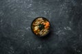 Japanese miso soup with tofu and salmon in a black bowl on a vintage colored background. Vertical view from above Royalty Free Stock Photo